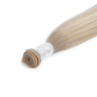 Blonde hair extension roll on a white background