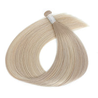Blonde hair extensions on a white background