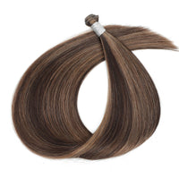 Genius Weft Mix shade brown and blonde mix hair extensions on a white background