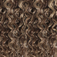 Close-up of wavy hair extensions with a brown and blonde color.
