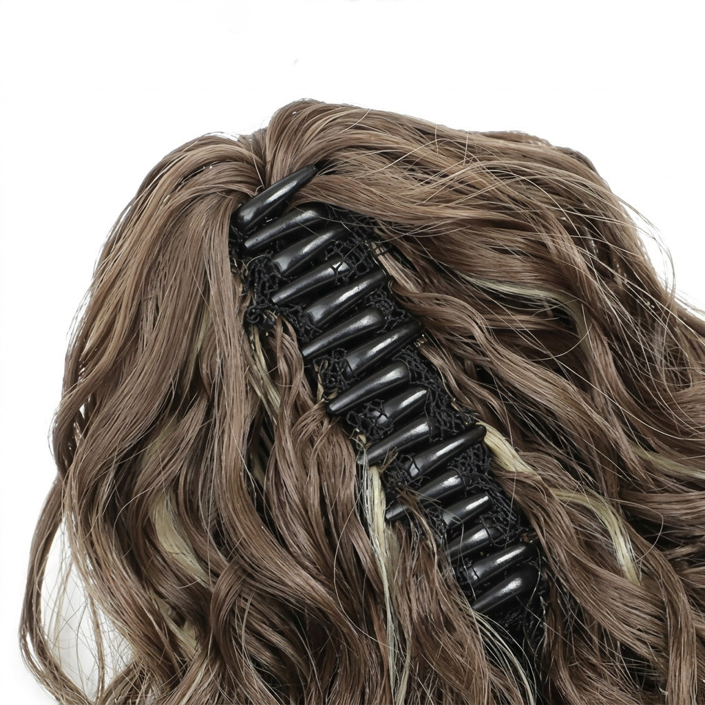 Brown hair extension with a black clip on a white background