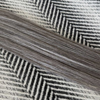 Close-up of gray and black herringbone pattern fabric