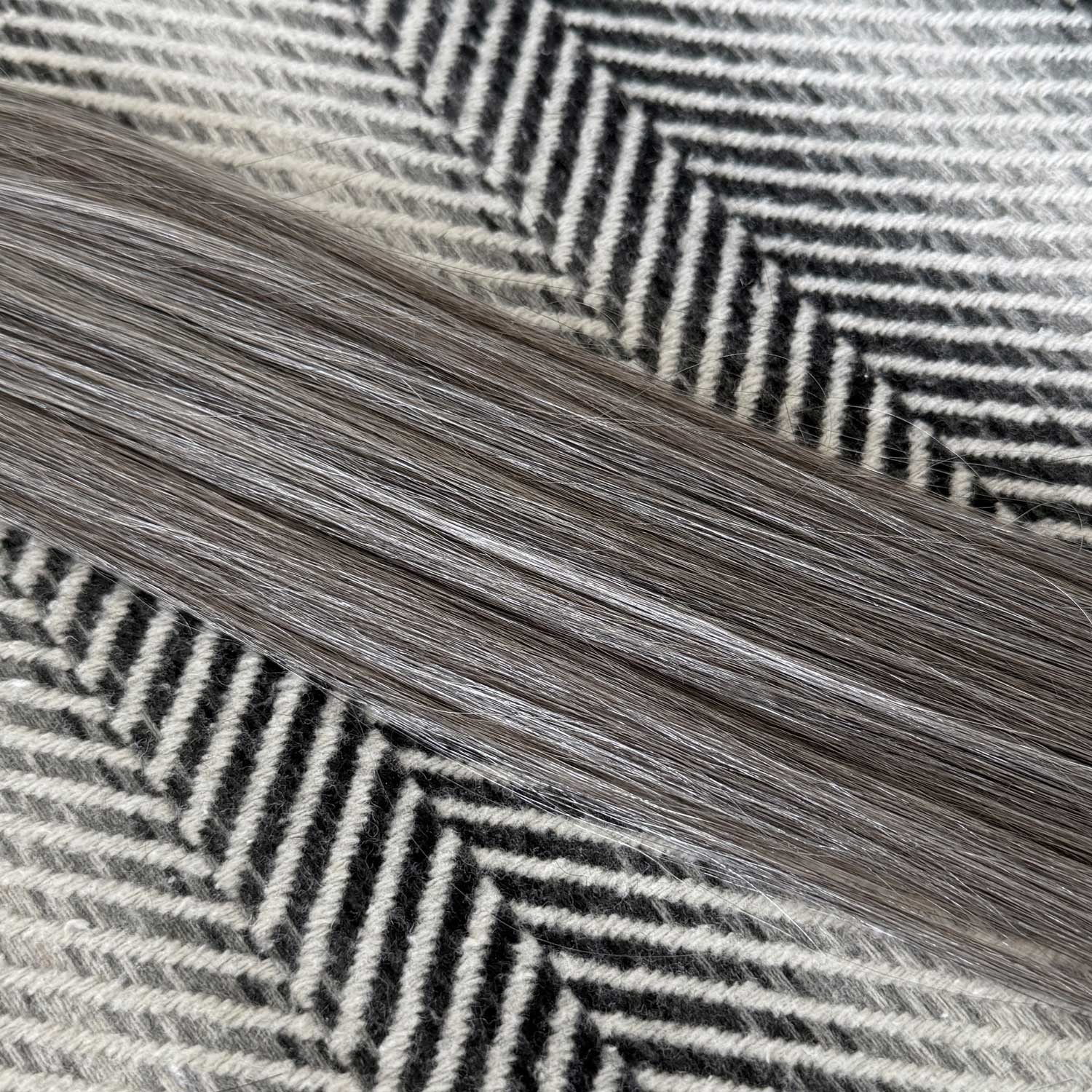Close-up of gray and black herringbone pattern fabric
