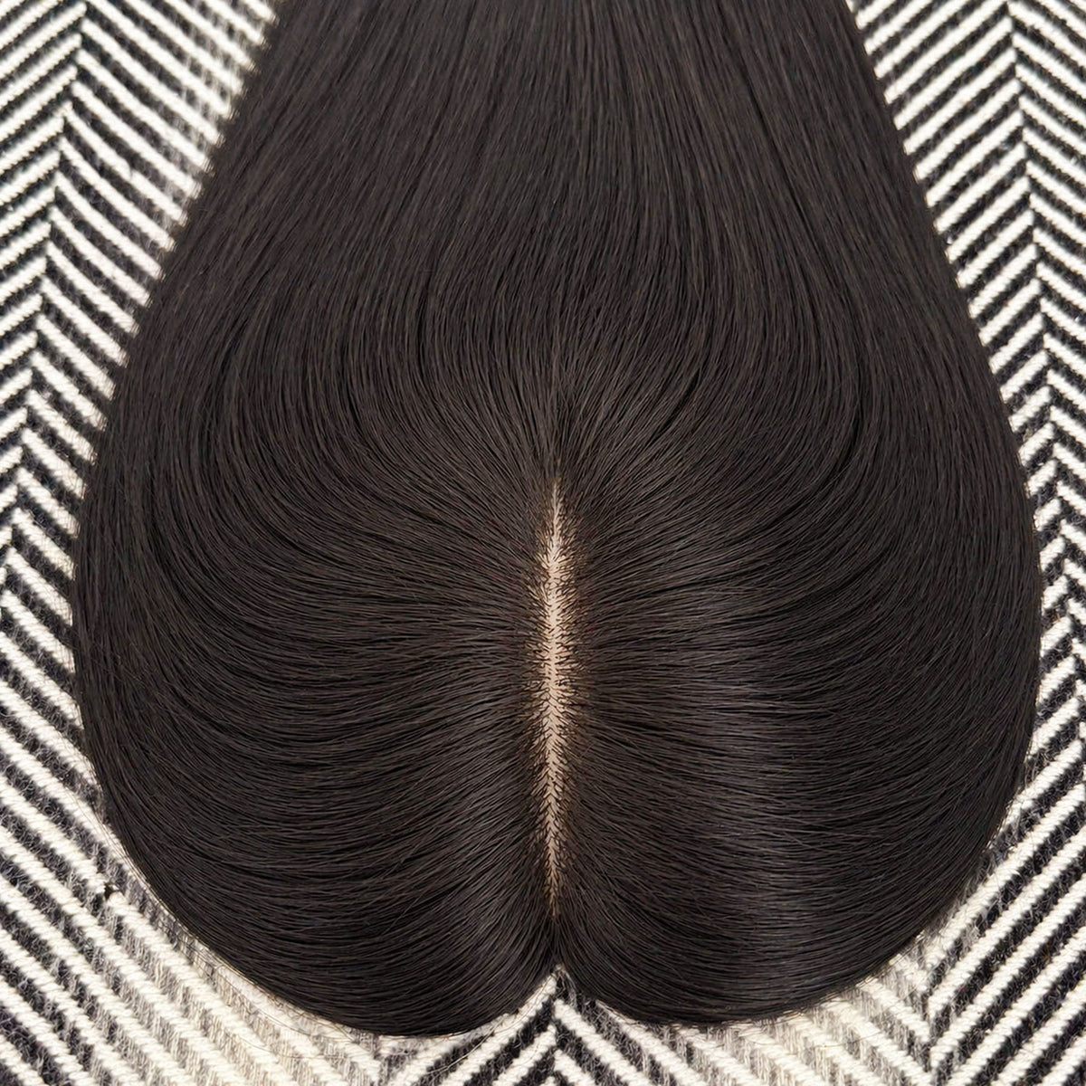 Black hairpiece on a patterned surface