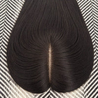 Black hairpiece on a patterned surface