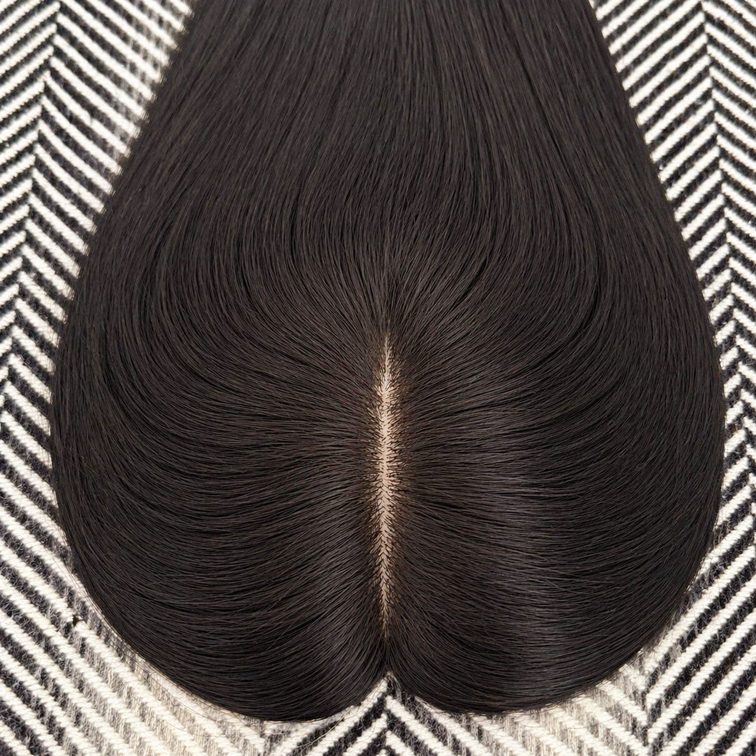 Black hairpiece on a patterned surface