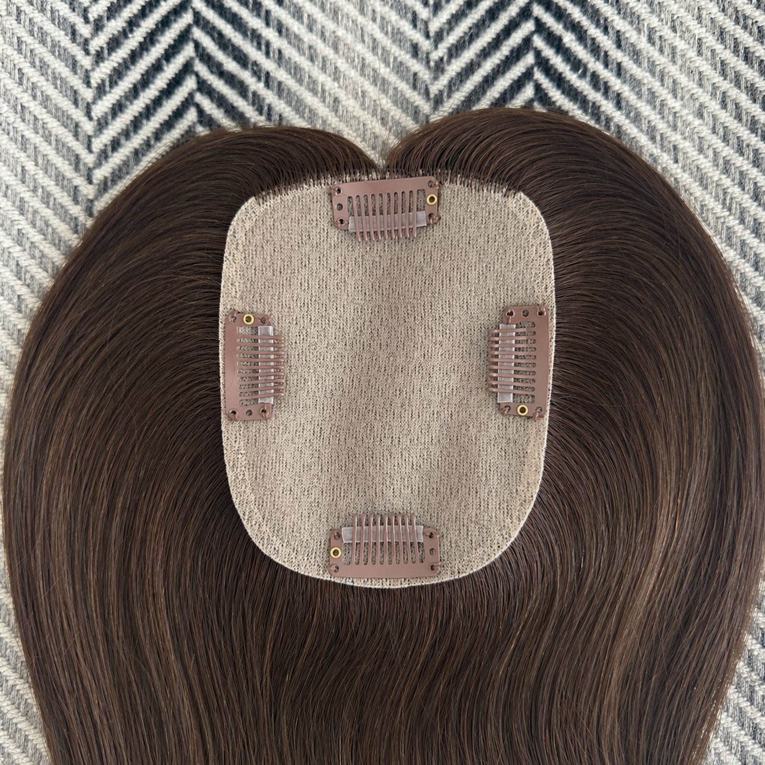 Hairpiece with a textured base on a patterned background