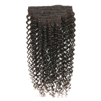 Set of curly hair extensions on a white background