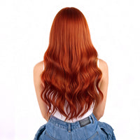 Person with long, wavy copper hair extensions on a white background