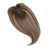 Brown hairpiece on a white background