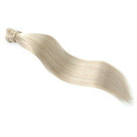 A single bundle of straight, wavy hair extensions in a light ash blonde color, displayed diagonally on a solid white background.