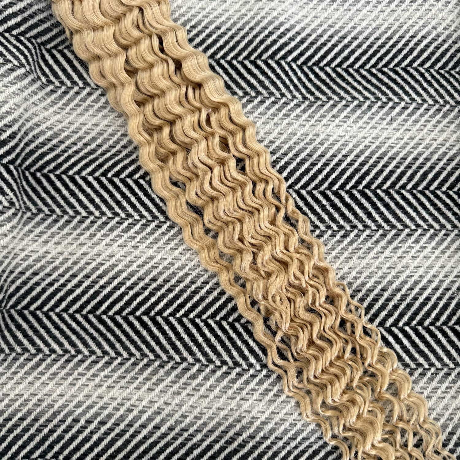 Beige chainmail on a textured black and white background