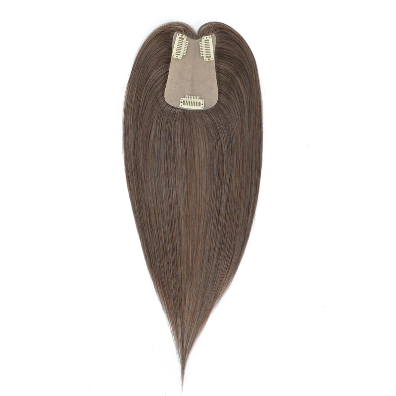 Brown hair extension with clip on a white background