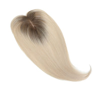 Blonde hair extension with gradient color on a white background