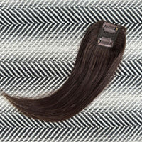 Brown hair extension on a patterned surface
