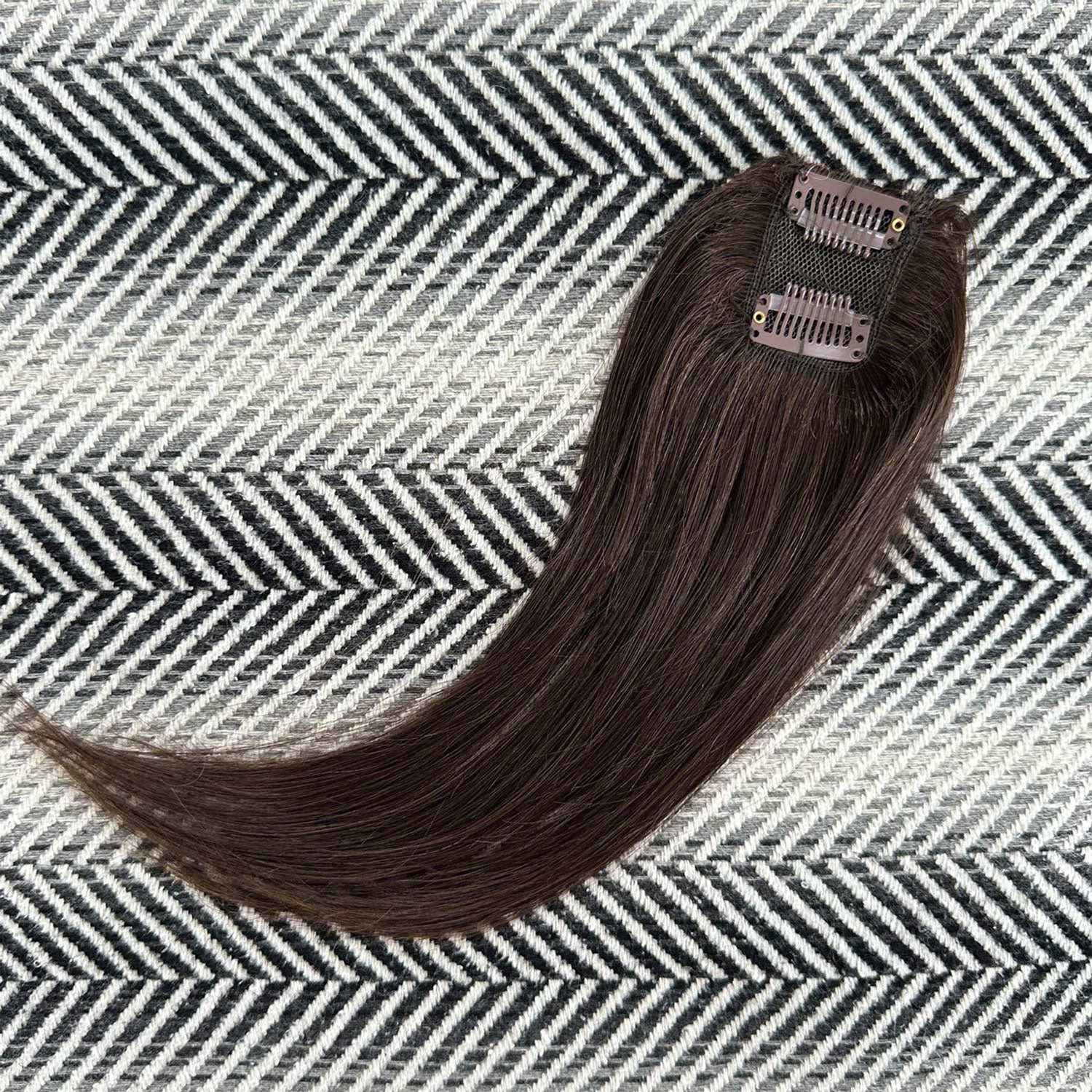 Brown hair extension on a patterned surface