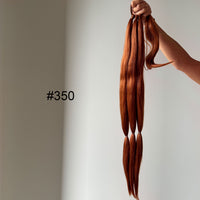 Copper hair extensions held by a hand against a neutral background with color code #350.