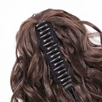 Black hair clip with decorative elements on a brown wig