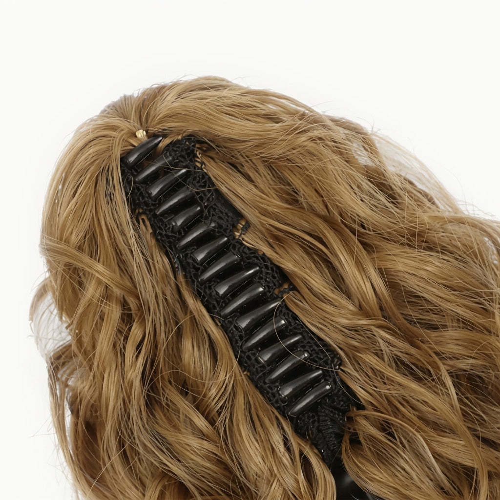 Black hair clip on a wig with blonde hair against a white background