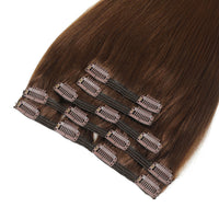 Brown clip-in hair extensions with multiple small metal clips attached to elastic bands, shown against a plain white background.