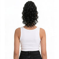 Person wearing a white tank top with curly hair on a white background