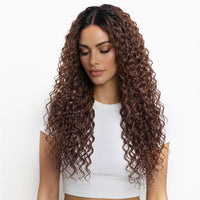 Woman with long, curly chestnut hair extensions wearing a white top on a white background