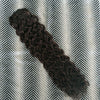 Curly hair extension on a textured gray and white background