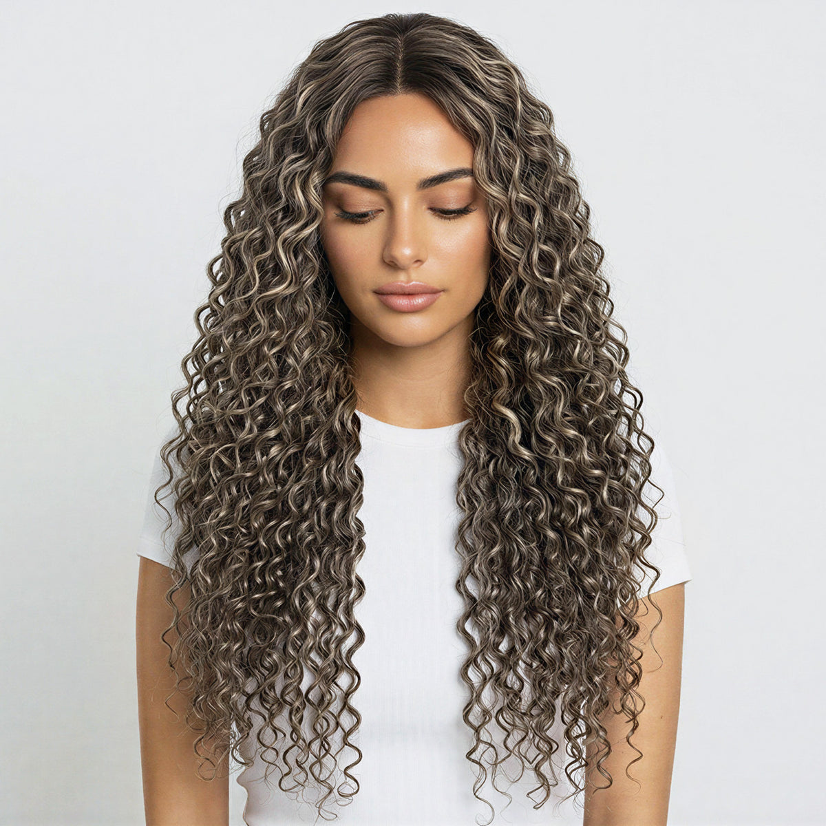 Woman with long, wavy, brown hair on a white background