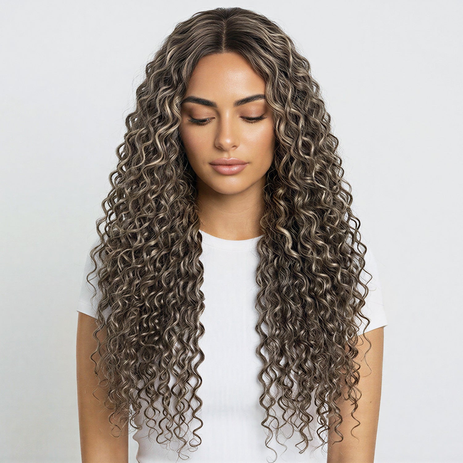 Woman with long, wavy, brown hair on a white background