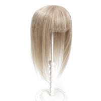Blonde wig on a white stand against a white background