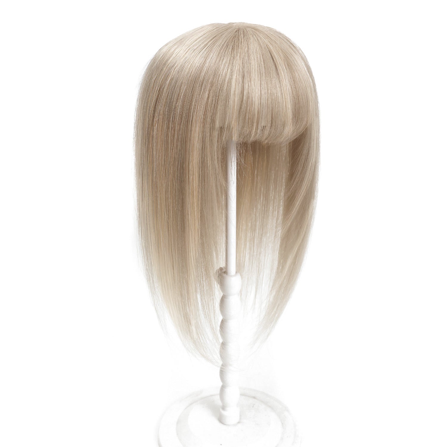 Blonde wig on a white stand against a white background