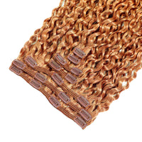 Set of copper hair extensions with clips on a white background