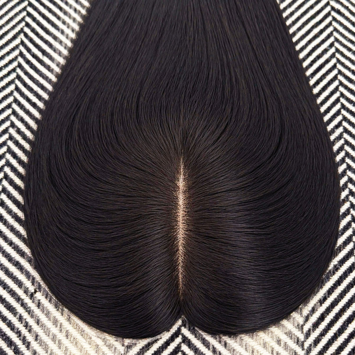 Black hairpiece on a patterned surface