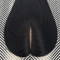 Black hairpiece on a patterned surface
