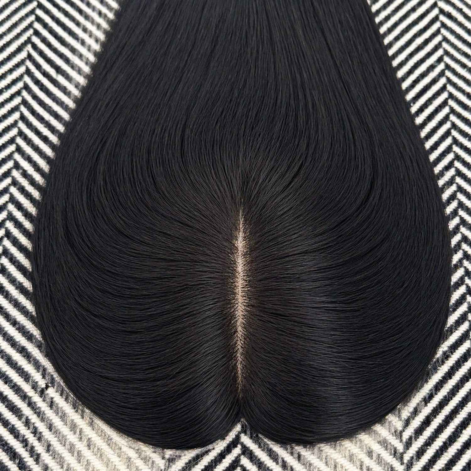 Black hairpiece on a patterned surface