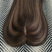 Brown hair extension on a patterned surface