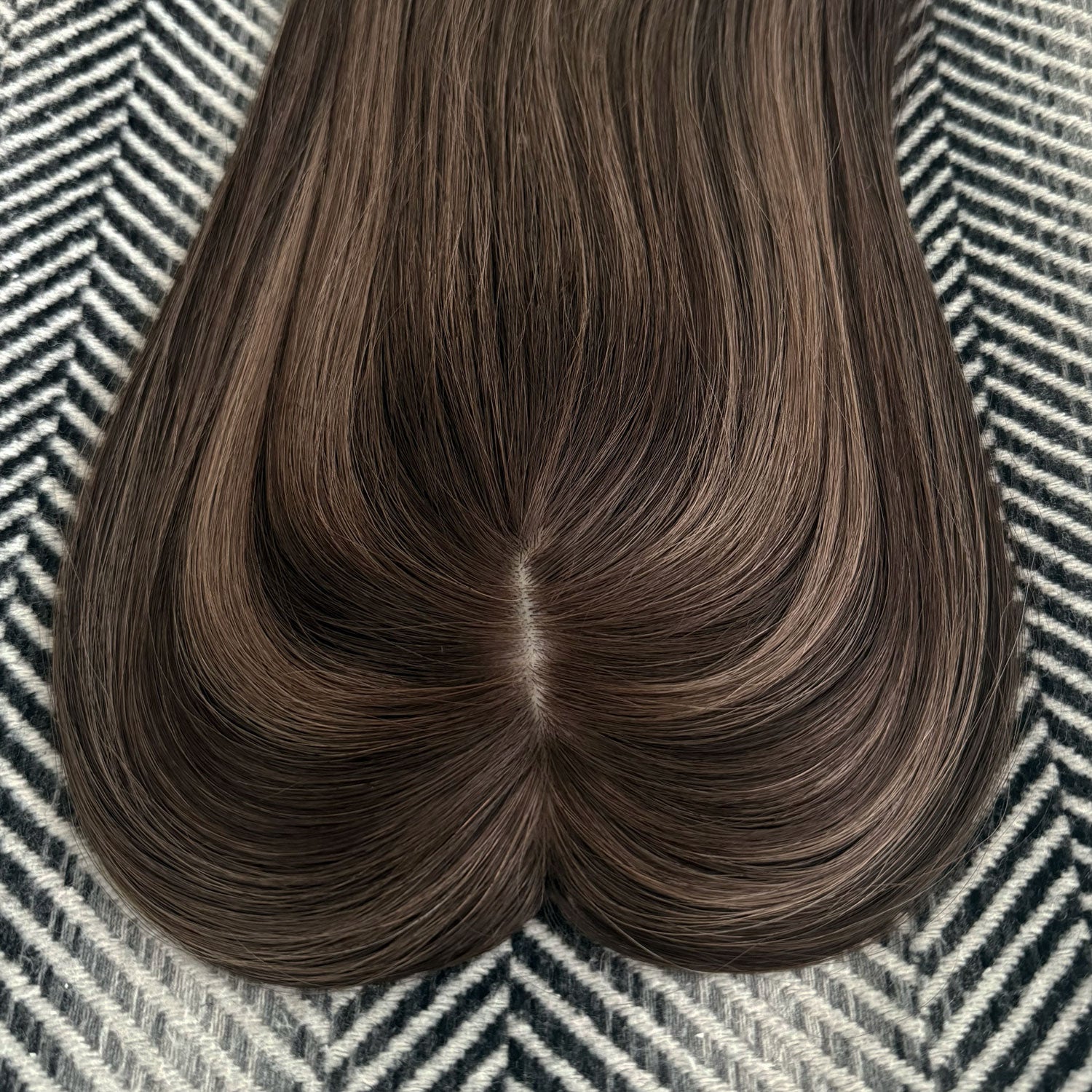Brown hair extension on a patterned surface