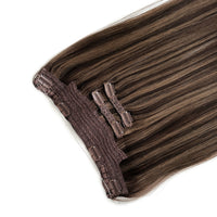 Set of brown hair extensions with clips on a white background