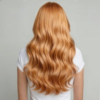 bright copper long, wavy, blonde hair wearing a white shirt on a gray background