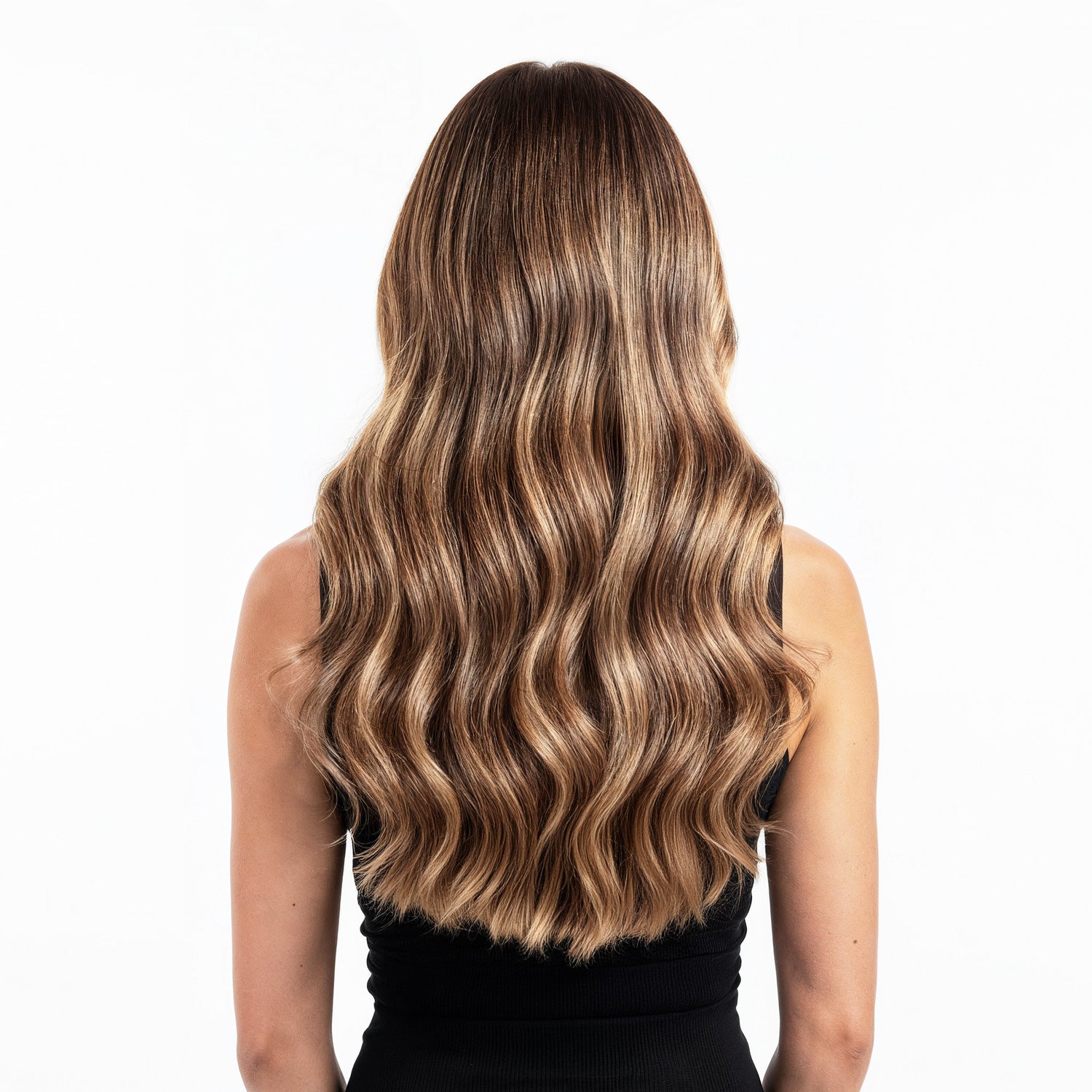 Woman with long, wavy, blonde hair  extensionson a white background