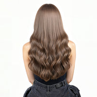 Woman with long, ash brown hair  extensions on a white background