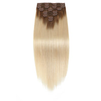 Set of blonde hair extensions with brown clips on a white background