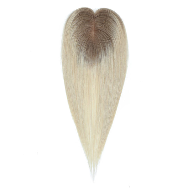 Blonde hair extension with gradient to brown on a white background