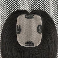 Hair extension with a textured patch on a patterned background