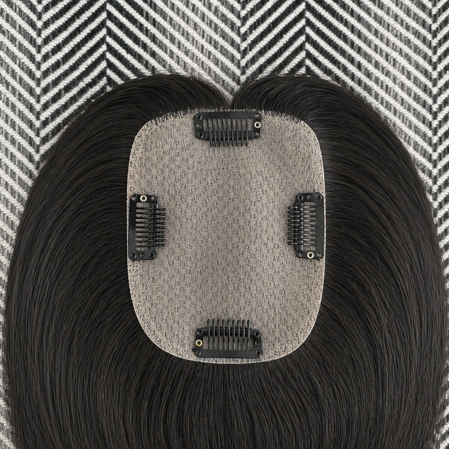 Hair extension with a textured patch on a patterned background
