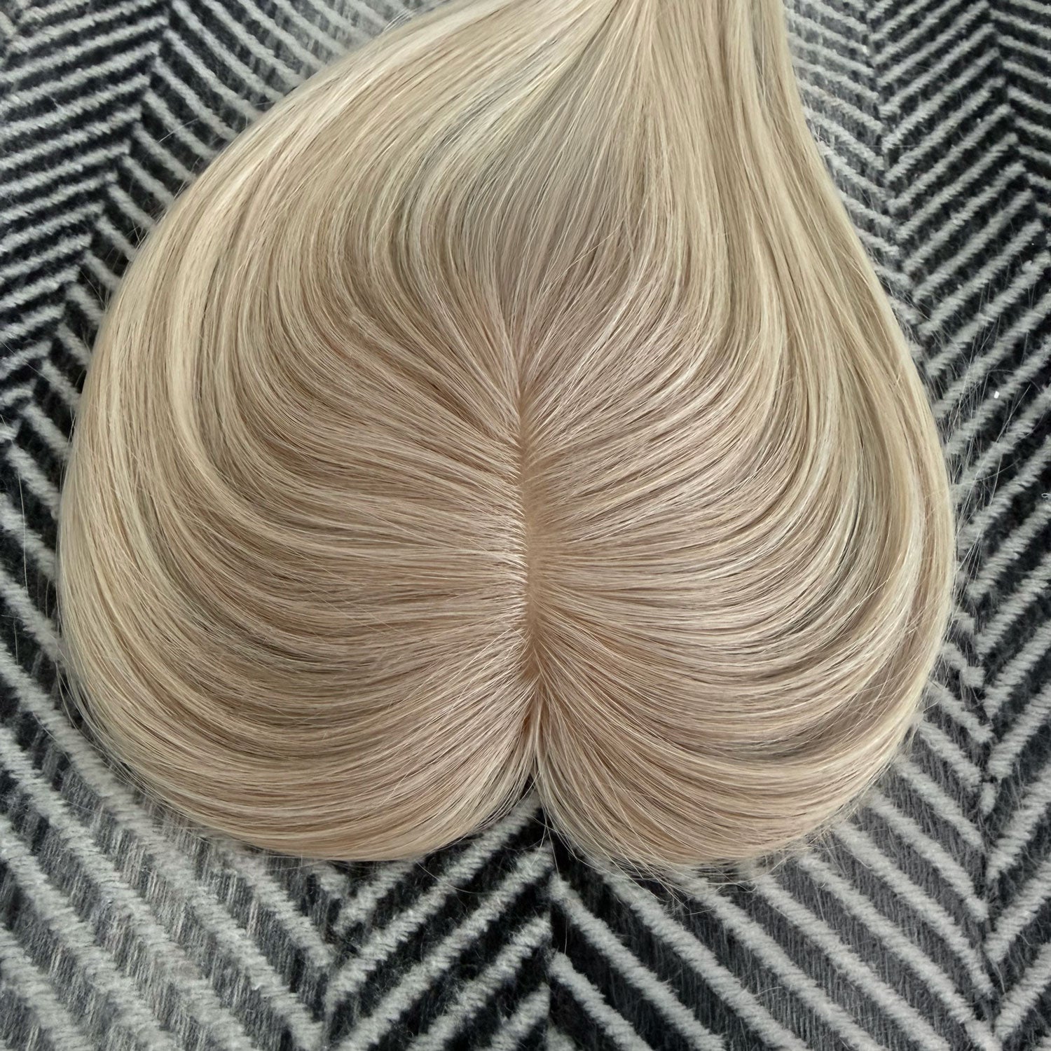 Blonde hair bun on a textured black and white background