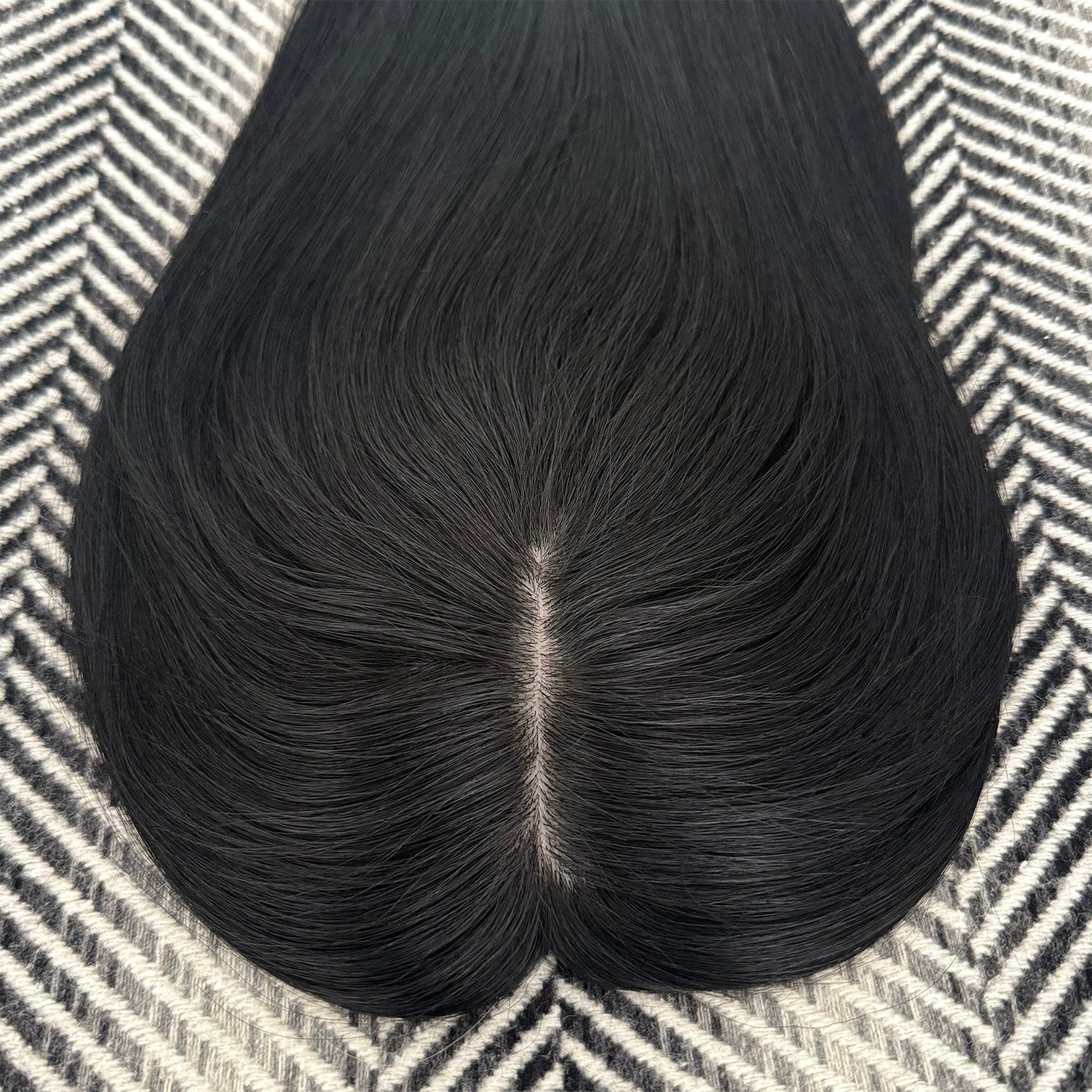 Black hairpiece on a patterned surface
