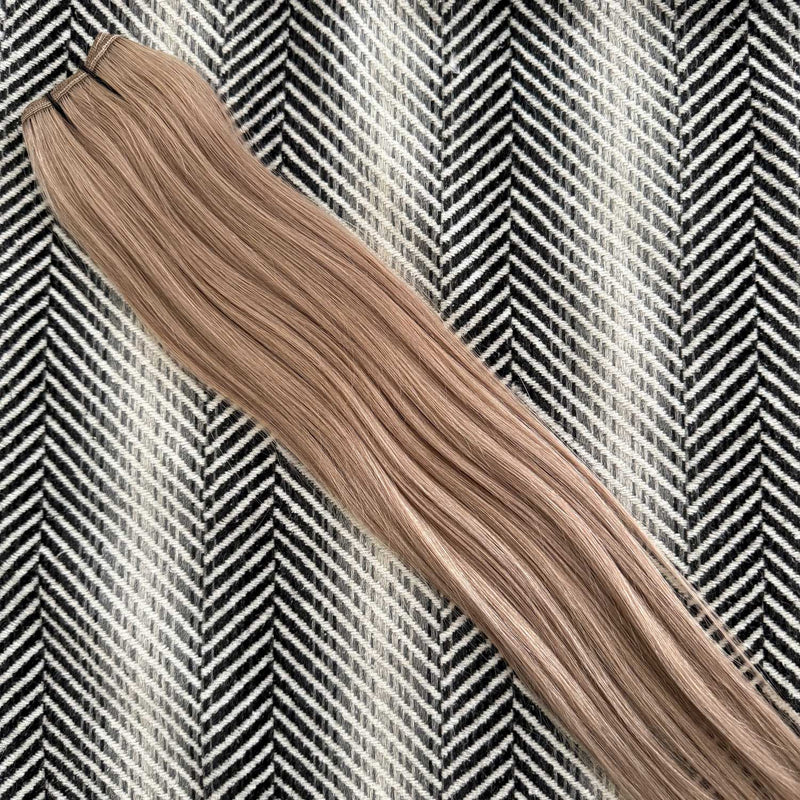 Blonde hair extensions on a patterned background