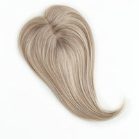Blonde hairpiece on a white background
