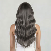 Person with long, wavy, gray hair on a plain background